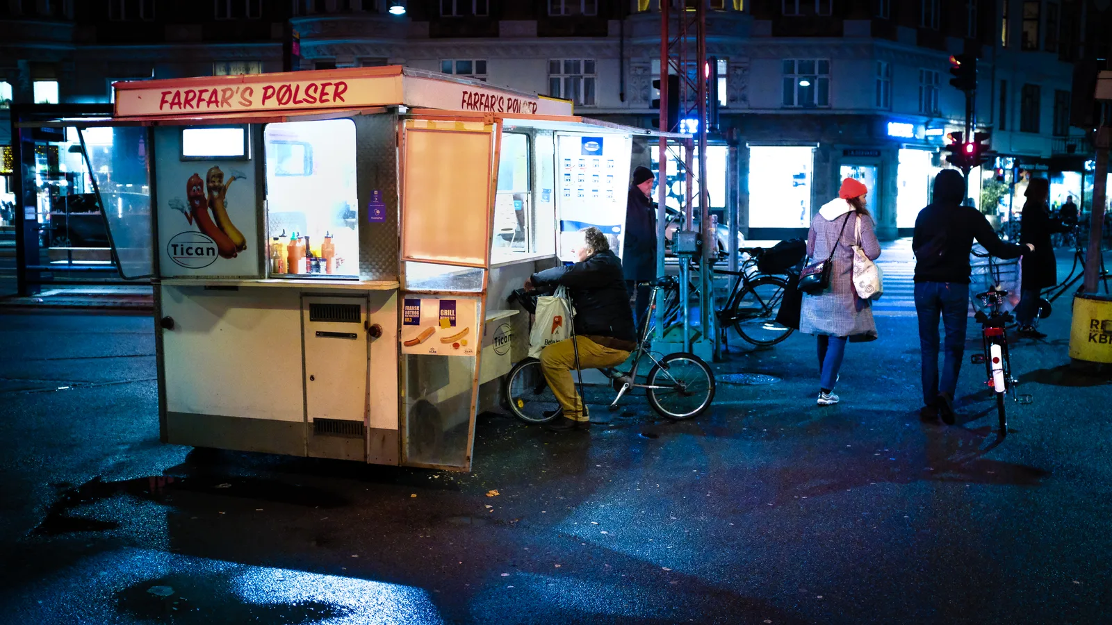 Classic Danish pølsevogn hot dog cart on Copenhagen street corner with iconic red signage