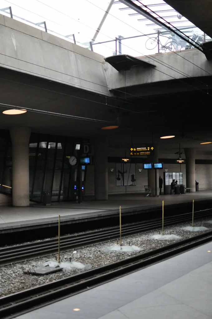 Copenhagen Airport railway station platform with DSB trains and travelers preparing to board