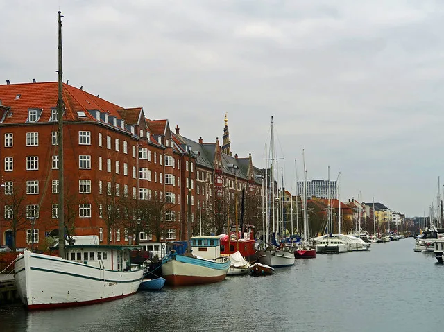 Traditional boat on the Christianshavn canal with historic Dutch-inspired architecture